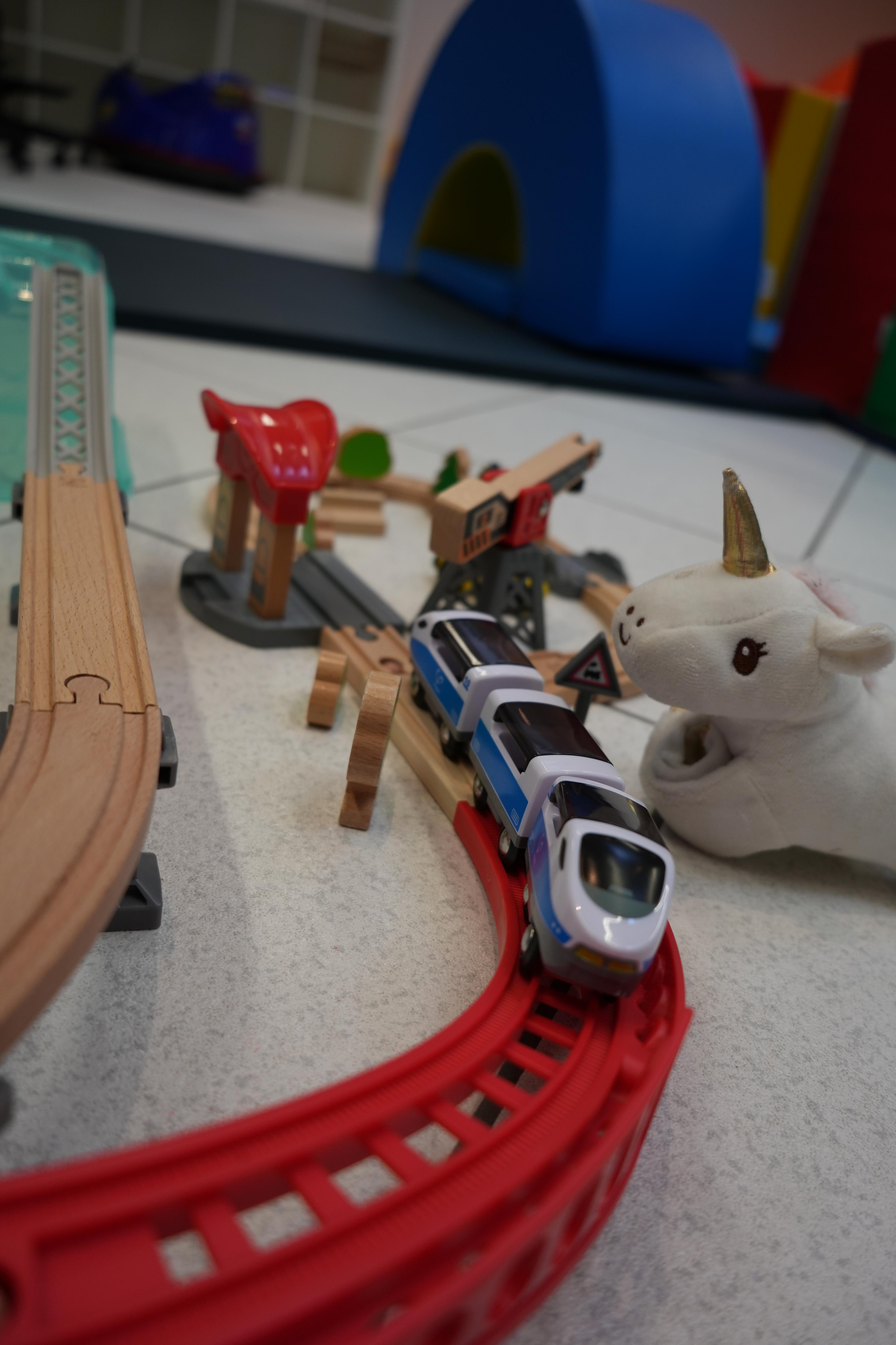 Wooden train scene with a unicorn toy — therapy disguised as play